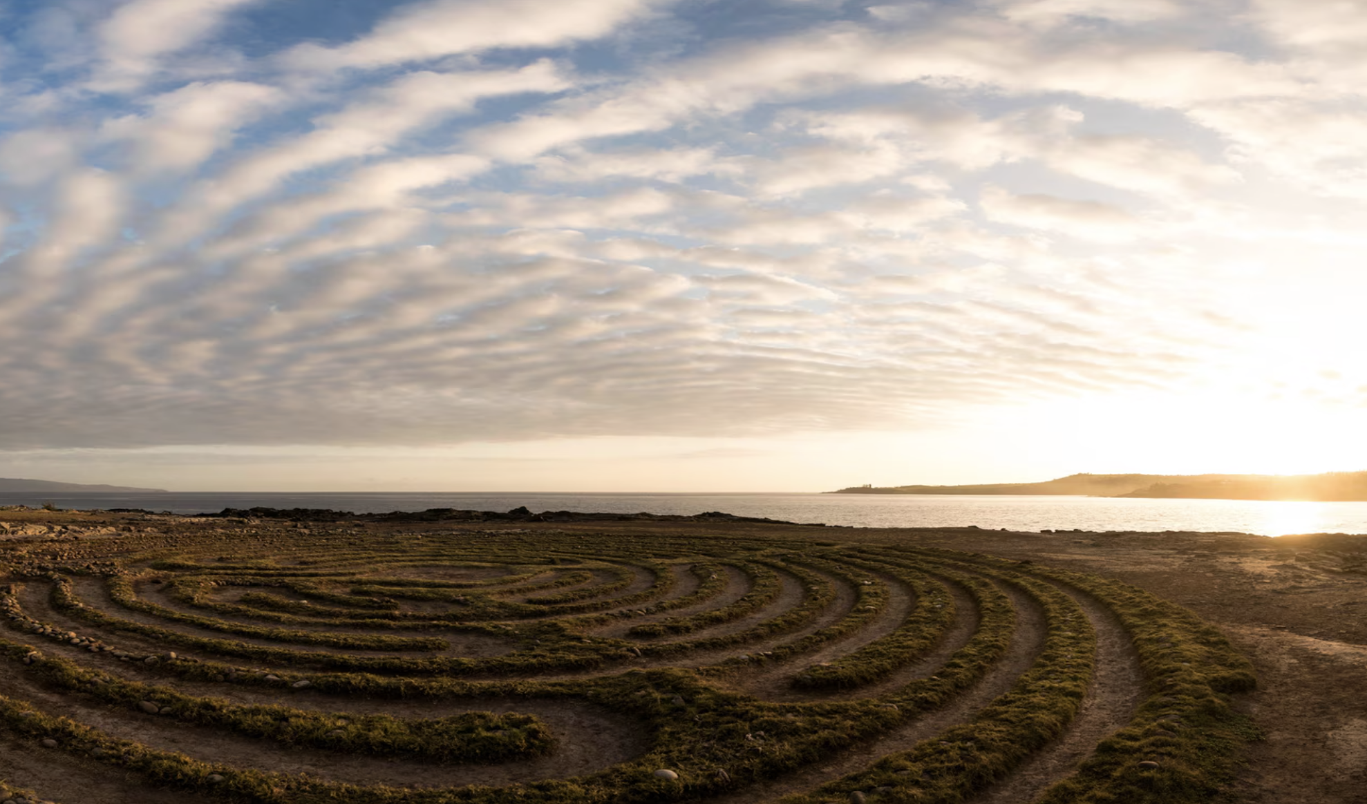 Kapalua Labyrinth at The Ritz-Carlton Kapalua overlooking the ocean at sunset with dramatic sky in Maui, Hawaii