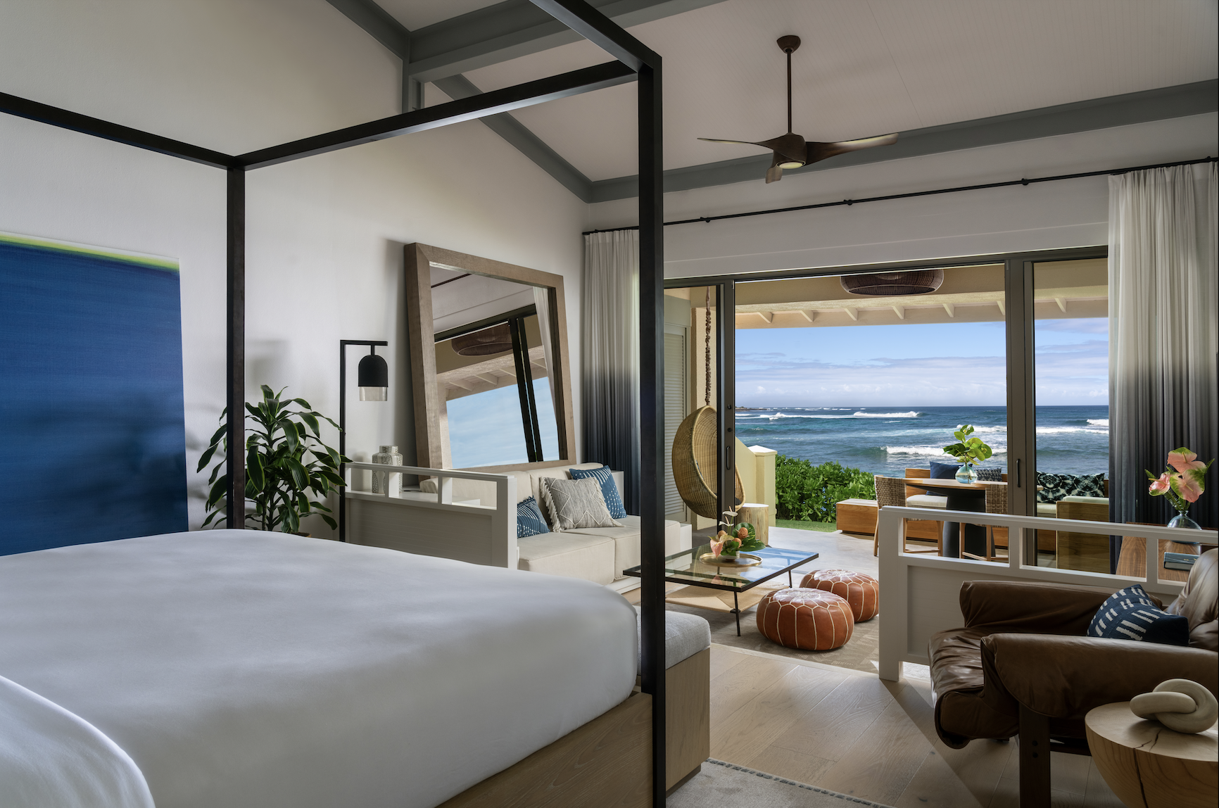 Oceanfront bungalow at The Ritz-Carlton Turtle Bay featuring a king bed, modern coastal décor, and a private lanai with direct ocean views.