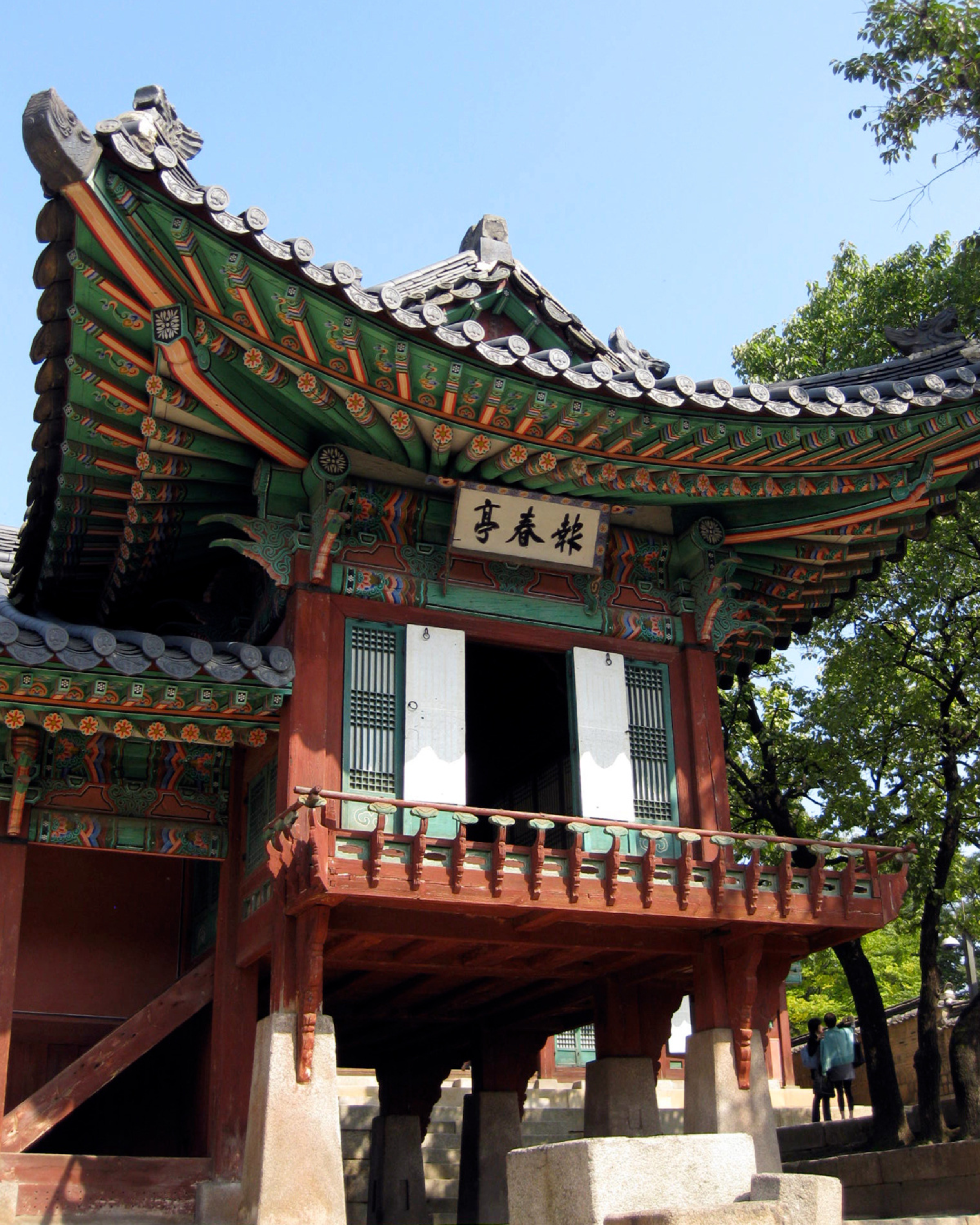 Traditional Korean pavilion with ornate painted wooden architecture at a historic palace in Seoul, South Korea.