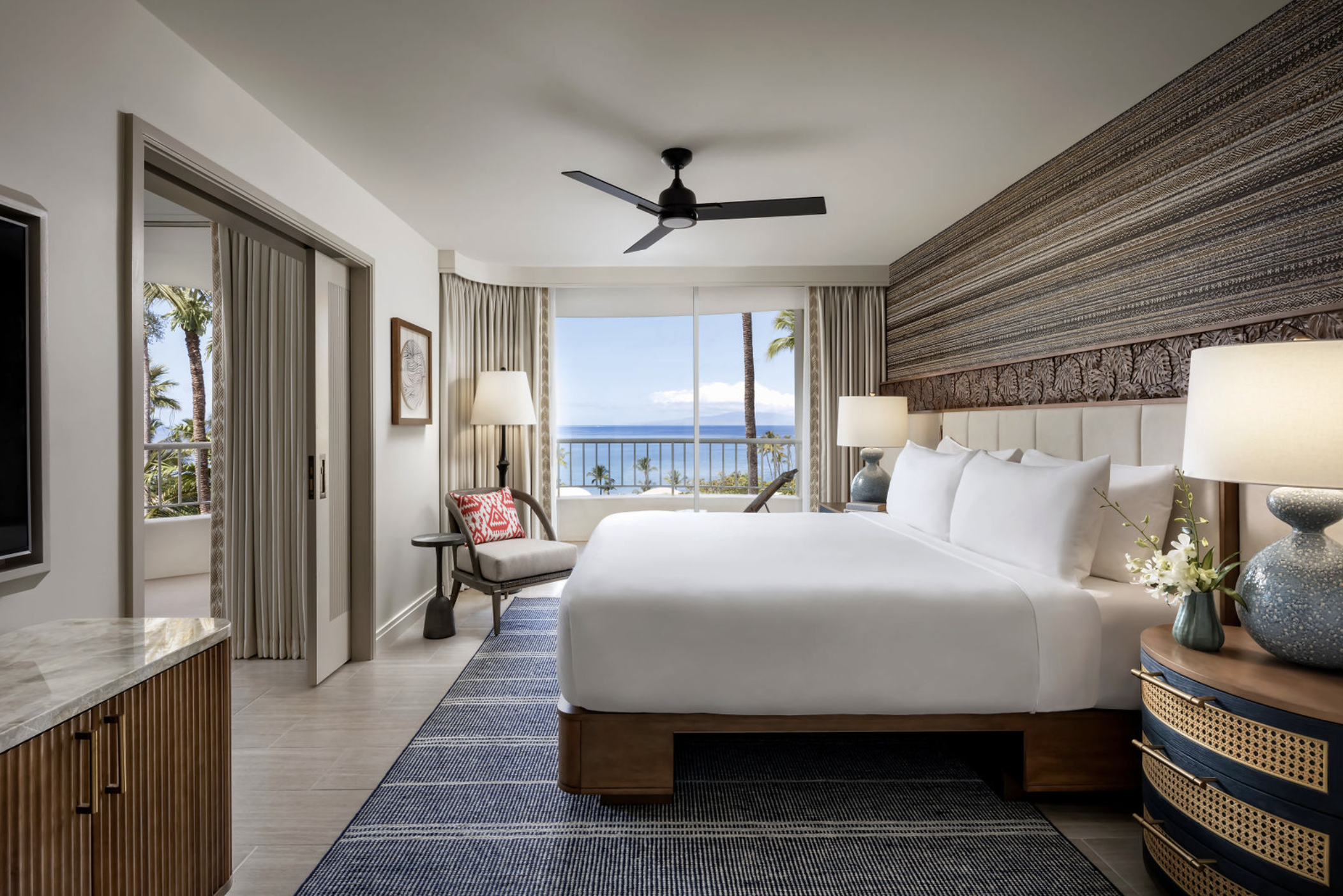 One-bedroom ocean view suite with private lanai, king bed, and tropical decor at Fairmont Kea Lani Maui