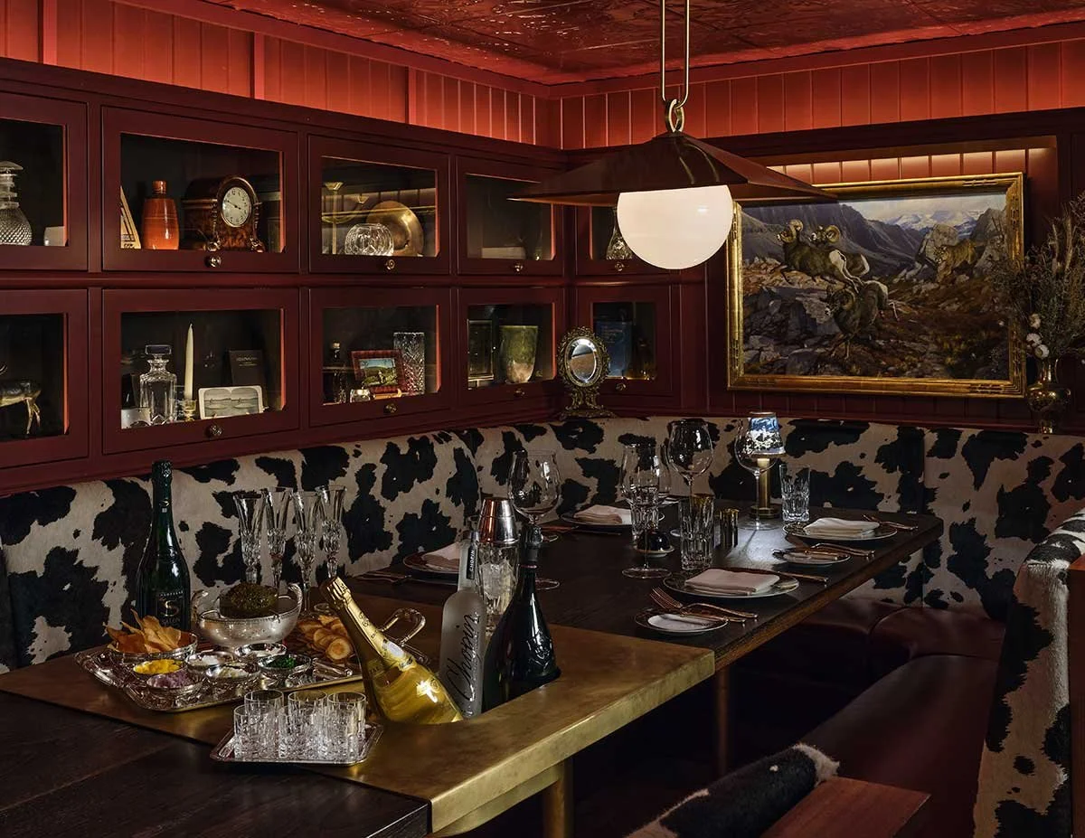 Intimate private dining room at Lone Mountain Ranch with rustic Western decor, cowhide seating, and elegant table setting in Montana