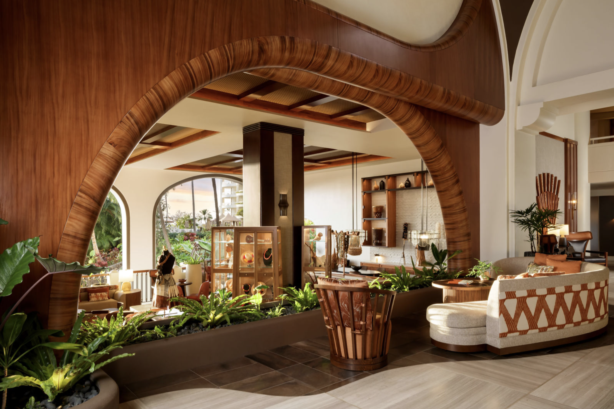Cultural lounge area in Fairmont Kea Lani Maui lobby with Hawaiian decor, wood archways, and artisan displays