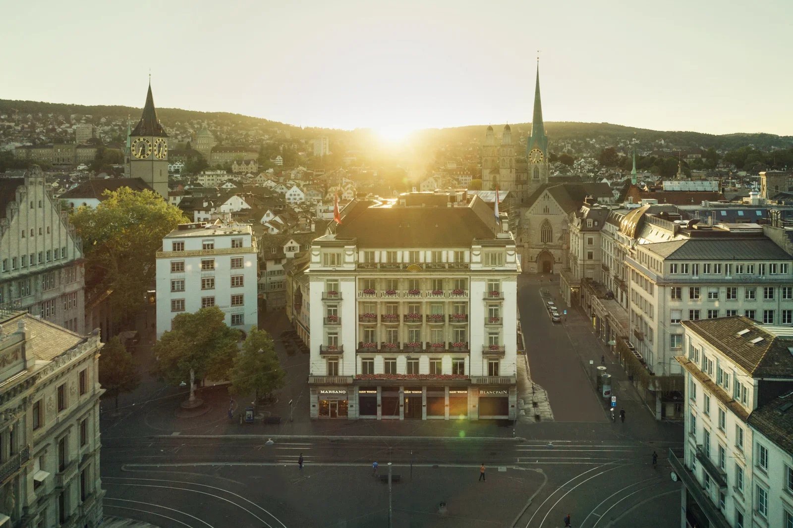 Sunrise over Zurich city center with historic buildings and church towers surrounding Paradeplatz in Switzerland