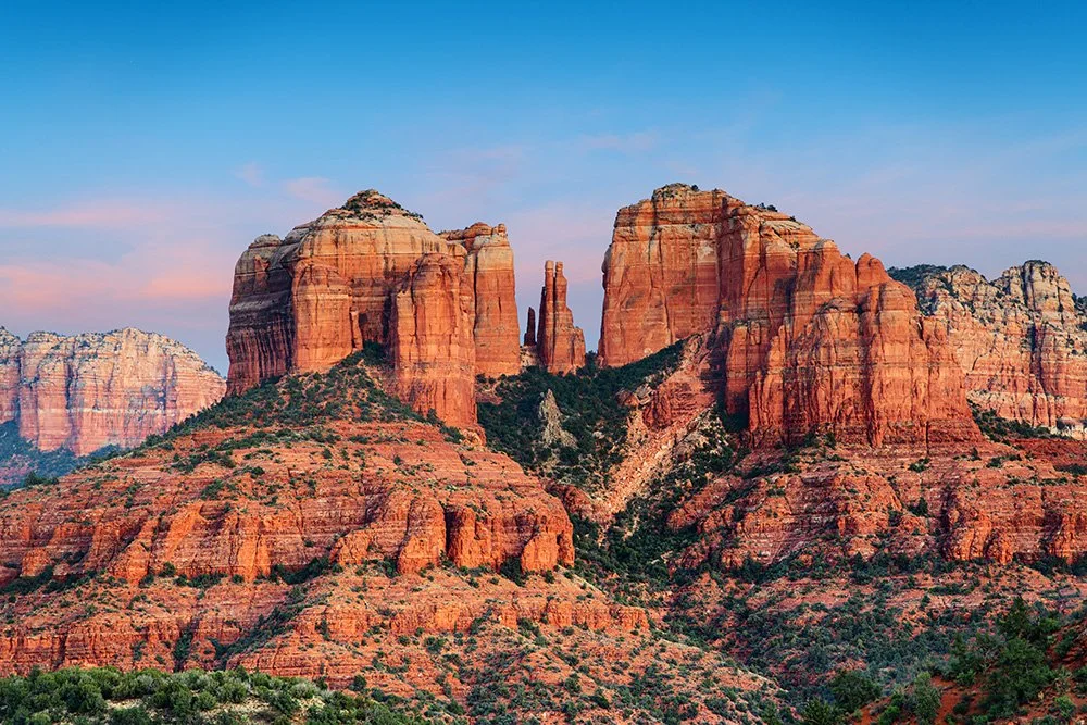 Cathedral Rock in Sedona, Arizona with dramatic red rock formations and desert landscape under a clear blue sky