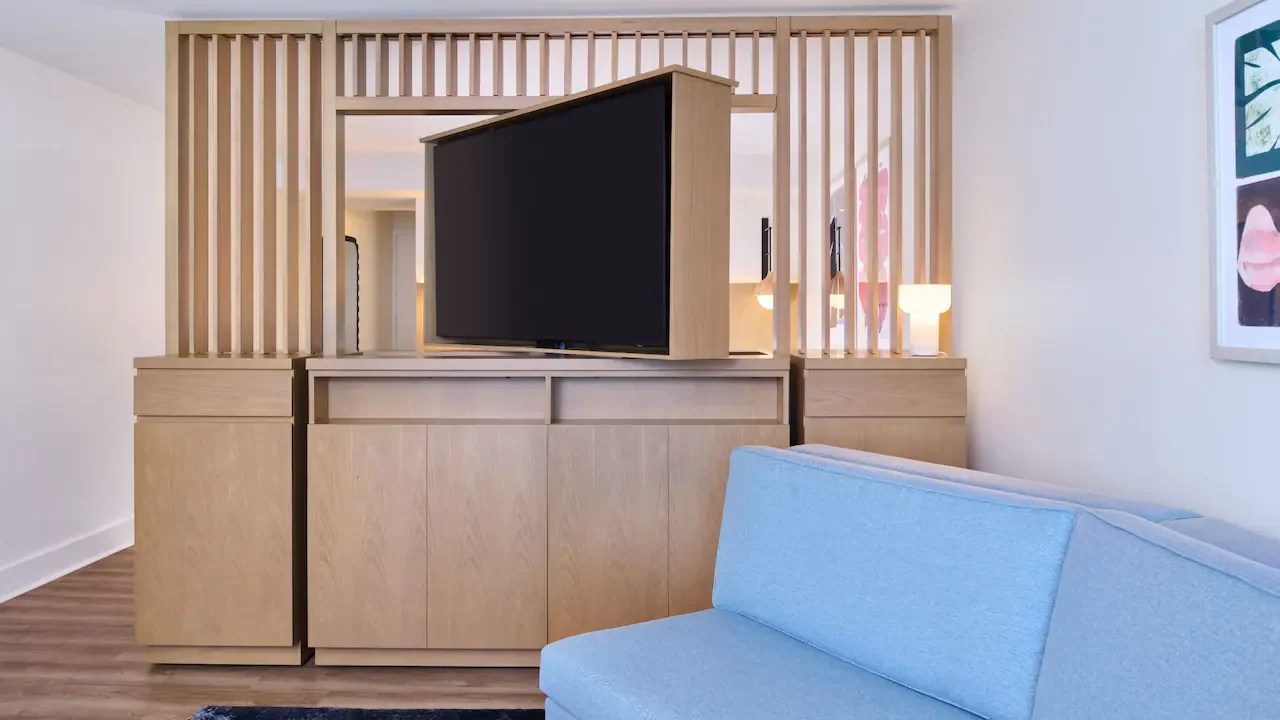 Junior Suite living area at Hyatt Regency Waikiki Beach Resort & Spa featuring modern furnishings, wood accents, and a partitioned bedroom layout in Honolulu, Oahu, Hawaii.