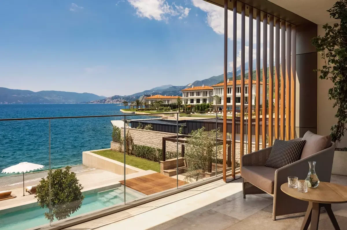 Private terrace overlooking the Adriatic Sea at One&Only Portonovi in Montenegro, featuring luxurious waterfront accommodations, a private plunge pool, and panoramic views of Boka Bay and the surrounding mountains.
