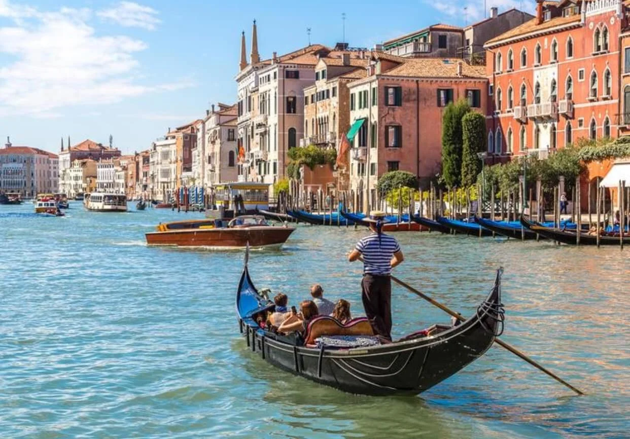Take a gondola ride while on vacation in Venice, Italy, 