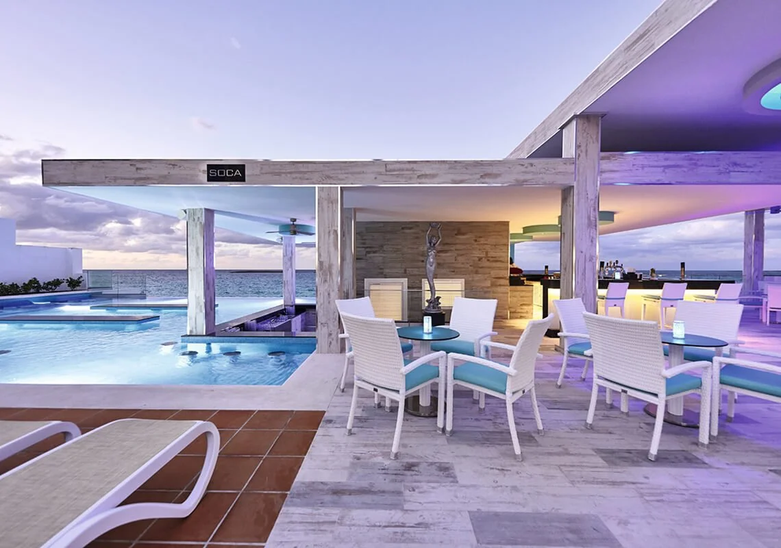 Poolside bar and seating area at Sunset Over water