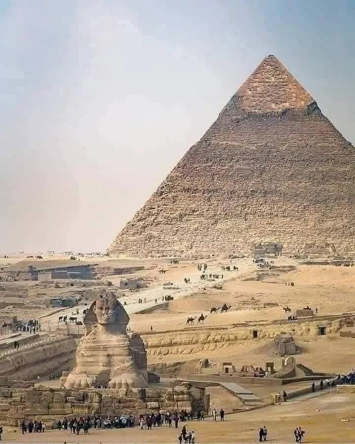 The Great Pyramid of Giza and the Great Sphinx of Giza in Egypt, with tourists visiting the site.