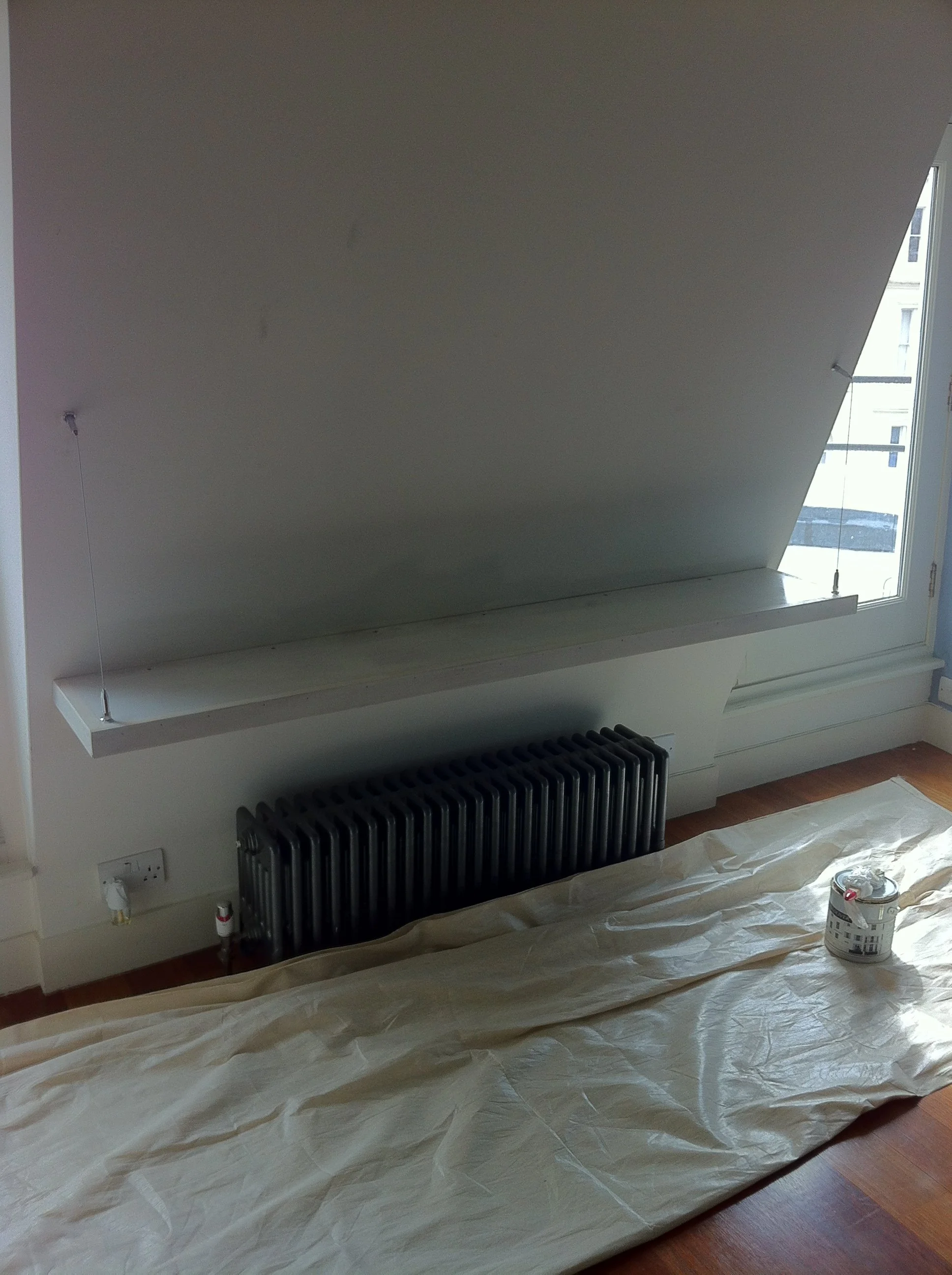 Red illuminated chair with gold accents and a separate curved red piece, set against a plain gray background.