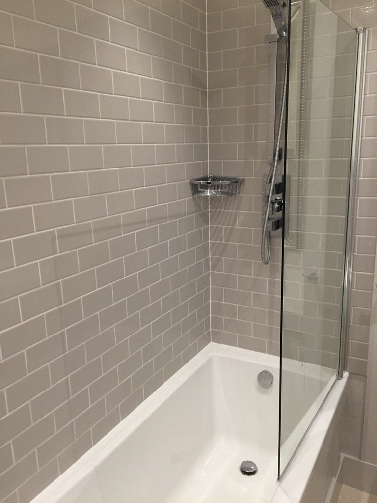 A red illuminated chair with gold accents and a separate matching footrest against a gray background.