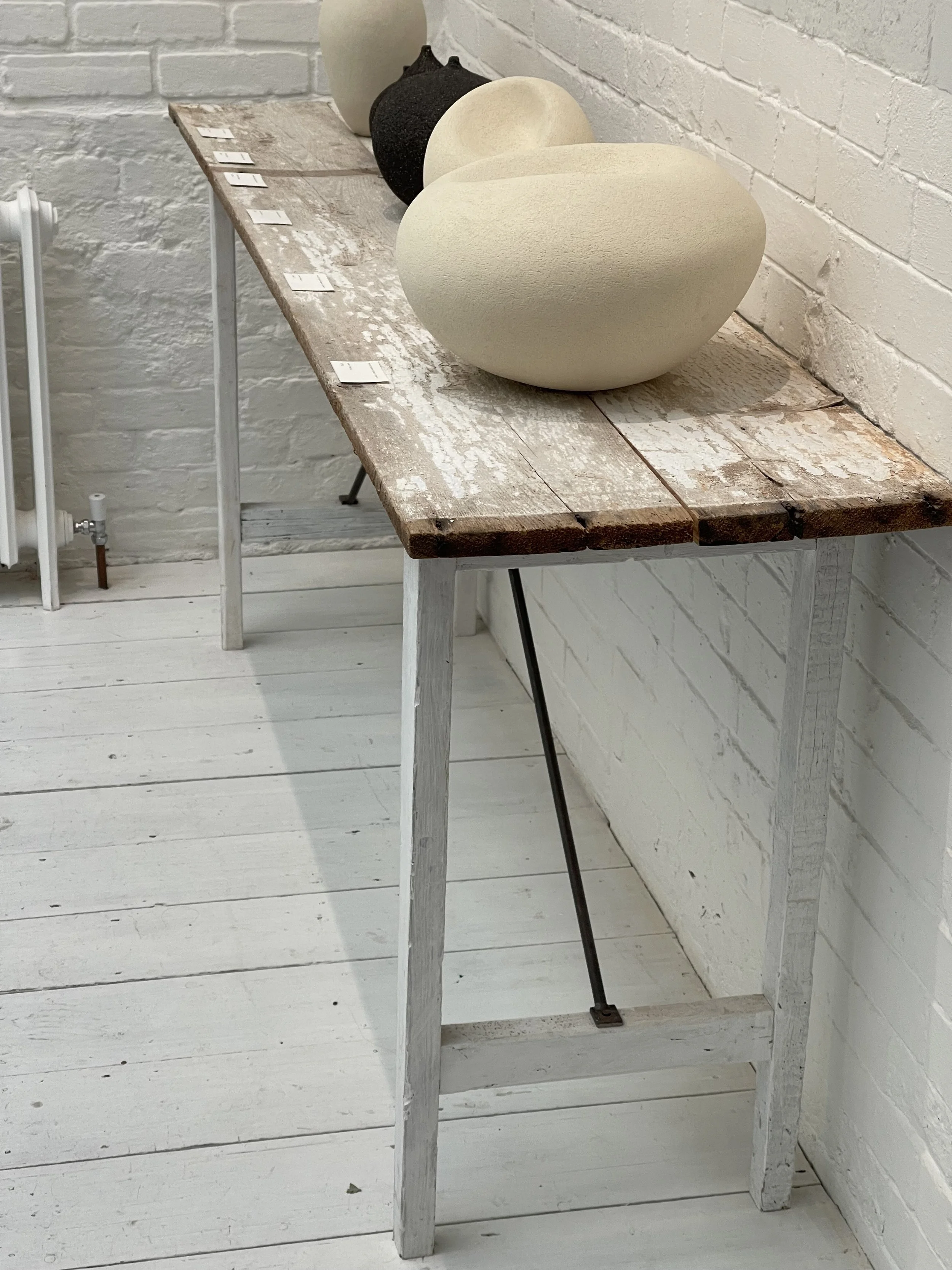 Red wooden chair with gold accents and a matching small table against a gray background