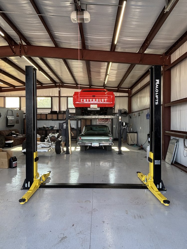 Two post lift installed in a shop with a classic car