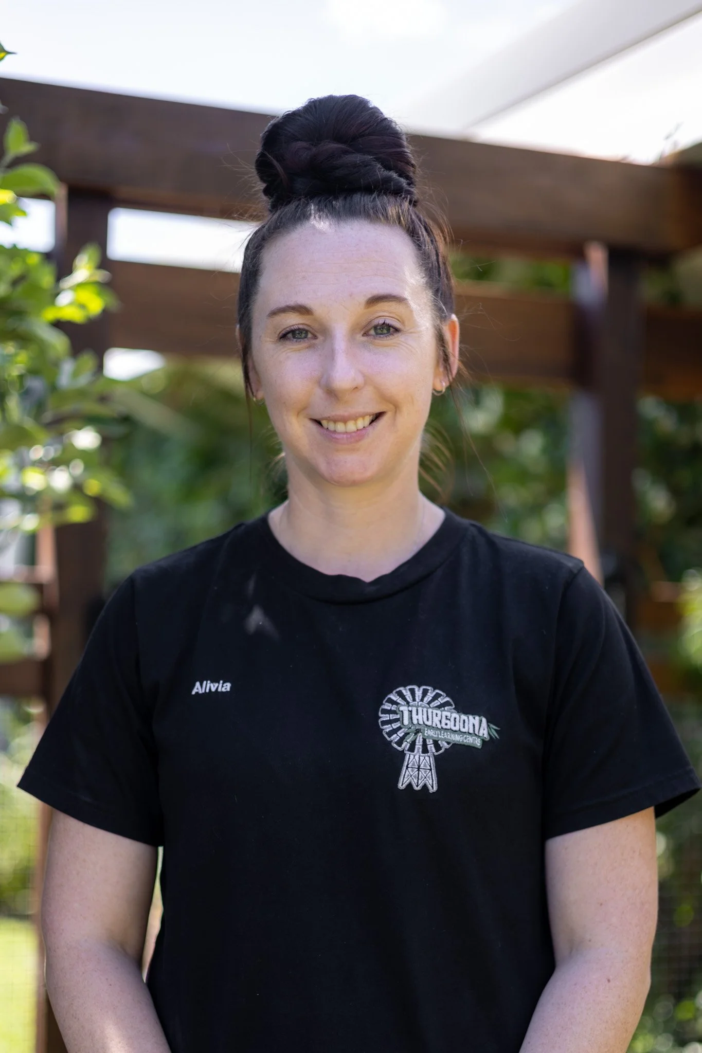 An early childhood educator with the nametag Jess