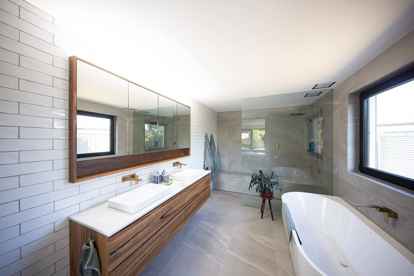 A bathroom built to last &mdash; timeless design, a rich walnut vanity, and a spacious shower with a built-in bench for everyday comfort and calm