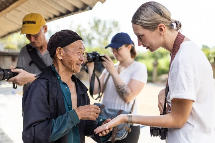 interacting with our subjects on a photography tour in Vietnam