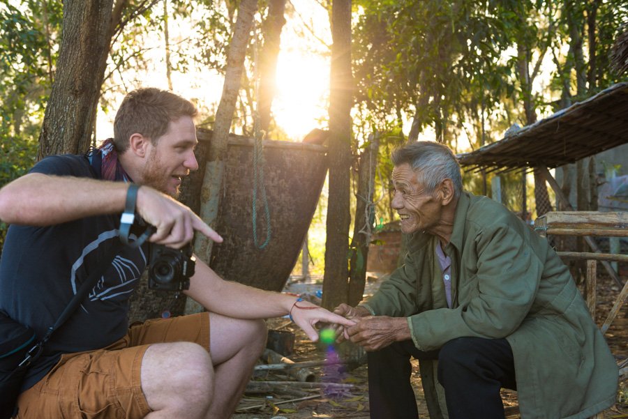 a photographer interacts with his subject for taking portraits