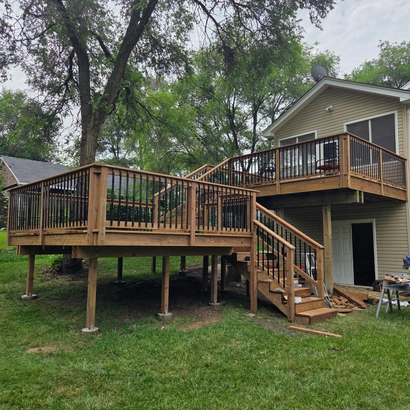 New multi level deck. Aluminum balusters with #cedartone decking make this a stunning place to hang outdoors.  #carpentry #deckbuilding
