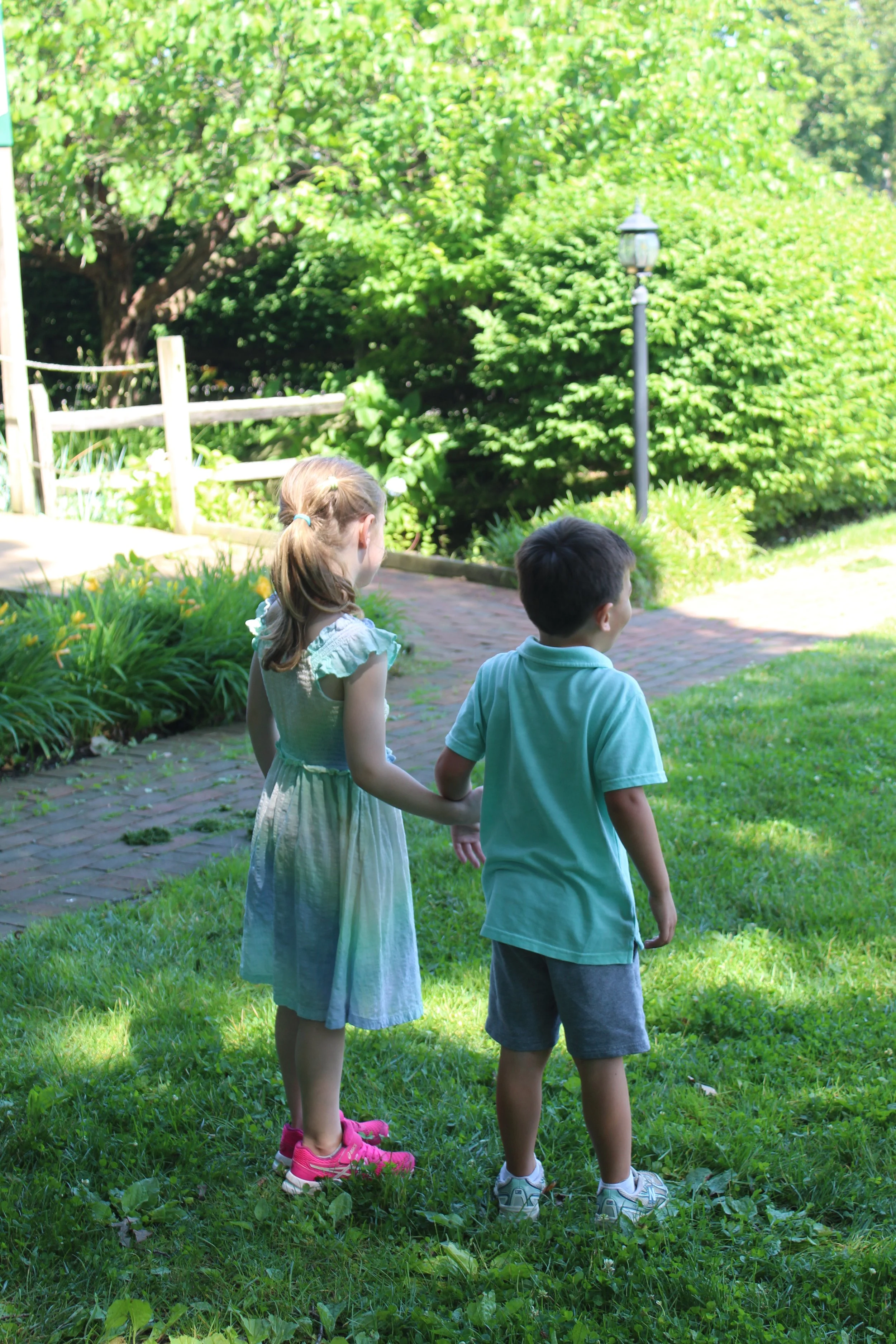 Two kids at a My Two Homes event holding hands.