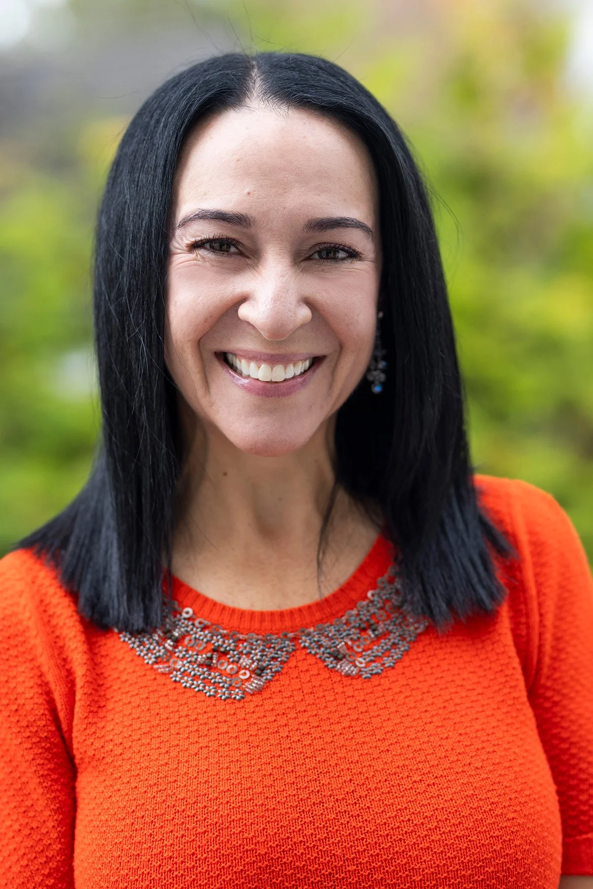 My Two Homes Founder Bella Akhtar smiling outside