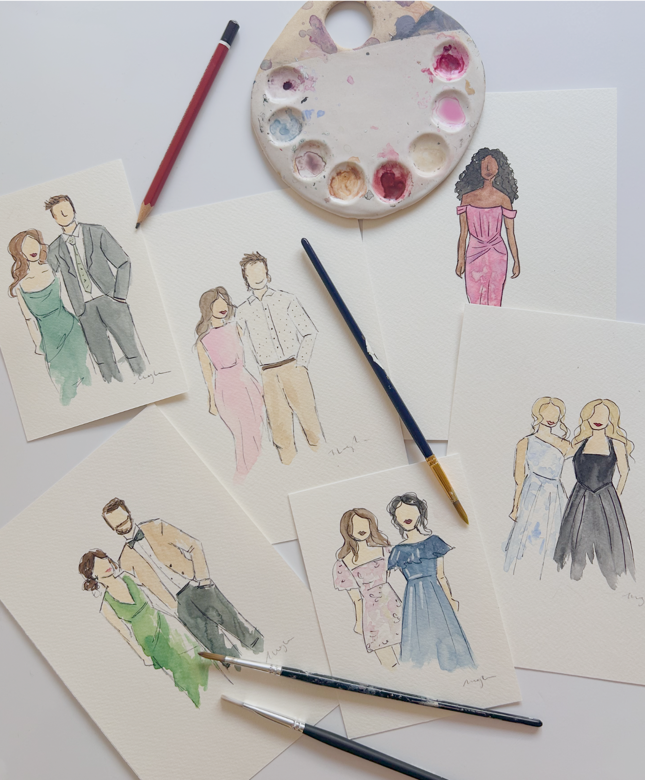 Collection of watercolor fashion sketches and illustrations of people in dresses, with paint palette and brushes on a white surface.