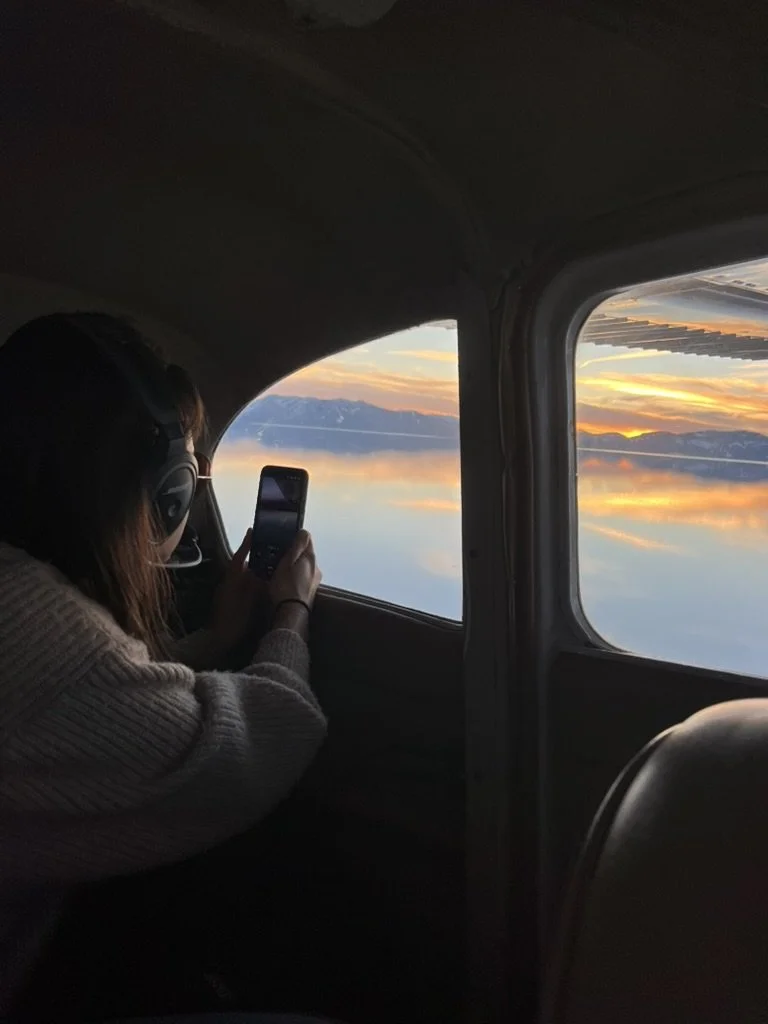 Woman enjoying a North Tahoe Aviation aerial sightseeing tour.