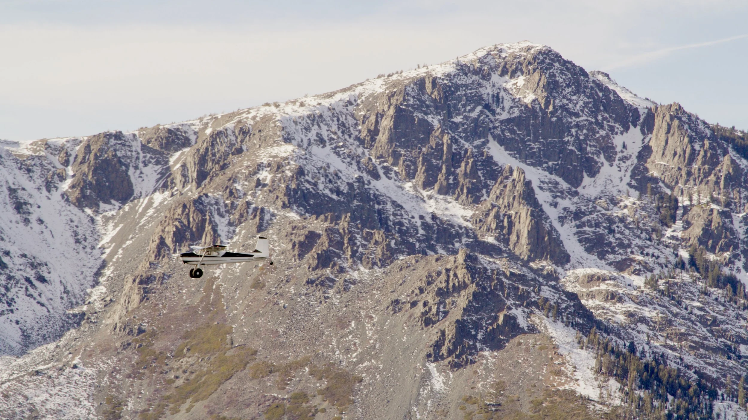 North Tahoe Aviation's Cessna 180 flying passed Mt. Tallac