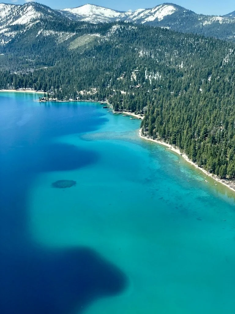 Lake Tahoe with snowy mountains and teal water