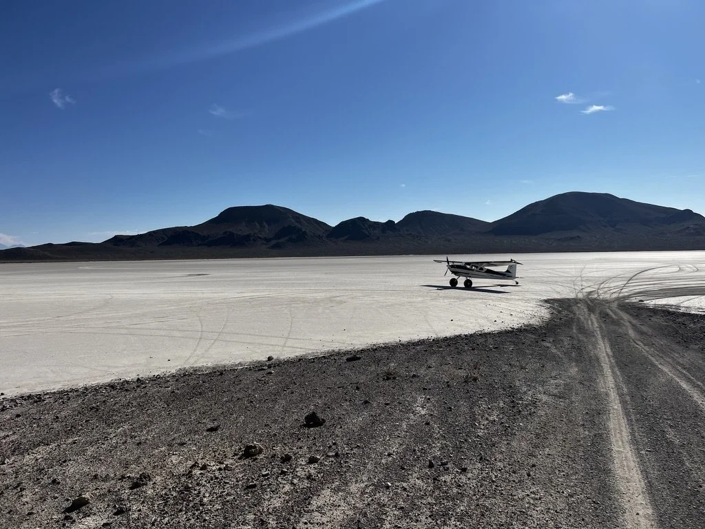 Cessna 180 bush plane at a dry lakebed in Nevada