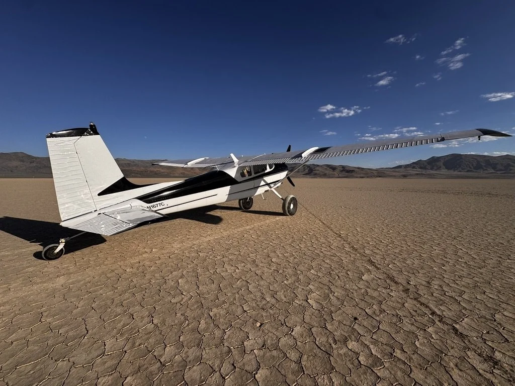 Cessna 180 bush plane at a dry lakebed in Nevada