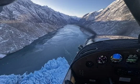 Airplane flying over a glacier in Alaska