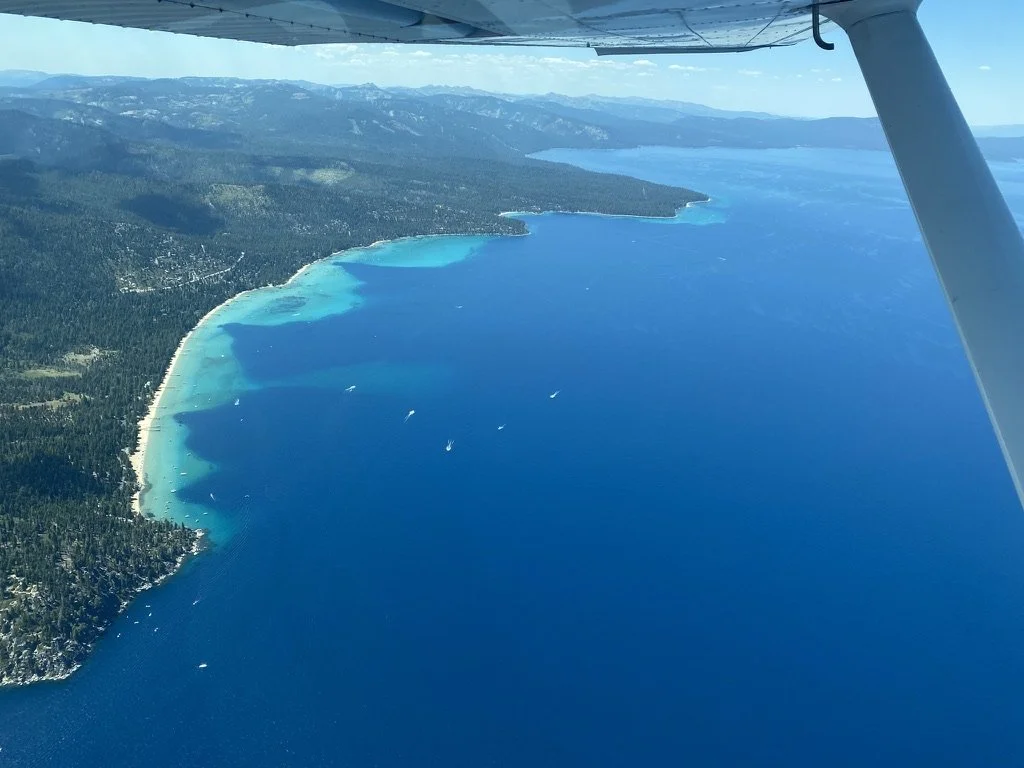 Lake Tahoe with emerald green water as seen from an airplane. North Tahoe Aviation air tour, sight seeing tour. Helicopter sightseeing tour. 