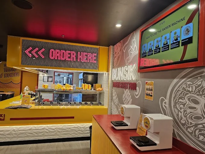 Completed Bunsik Griffith restaurant fit-out featuring a dedicated ordering counter, self-service ramen station and efficient customer service layout.