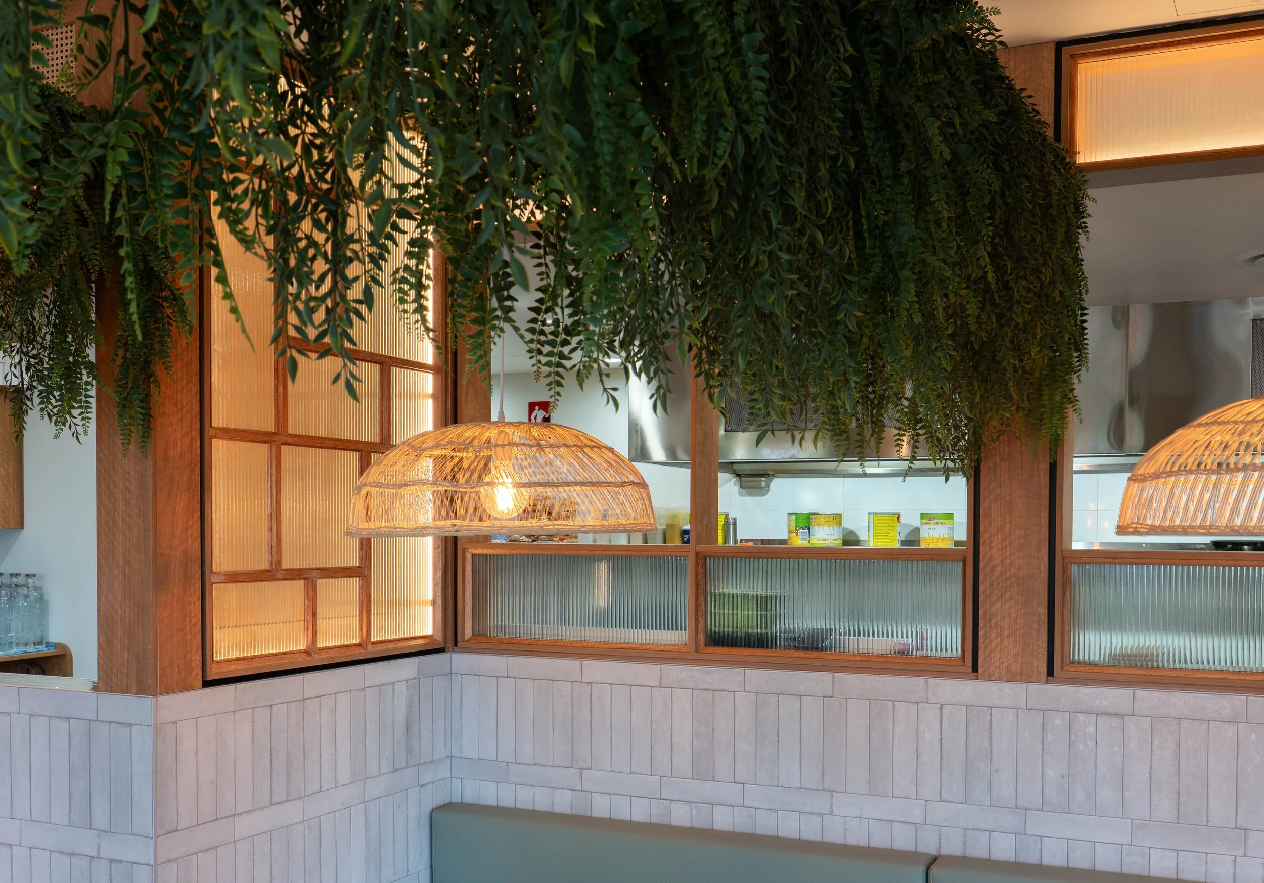 Fluted glass partition providing subtle privacy while maintaining an open restaurant layout.