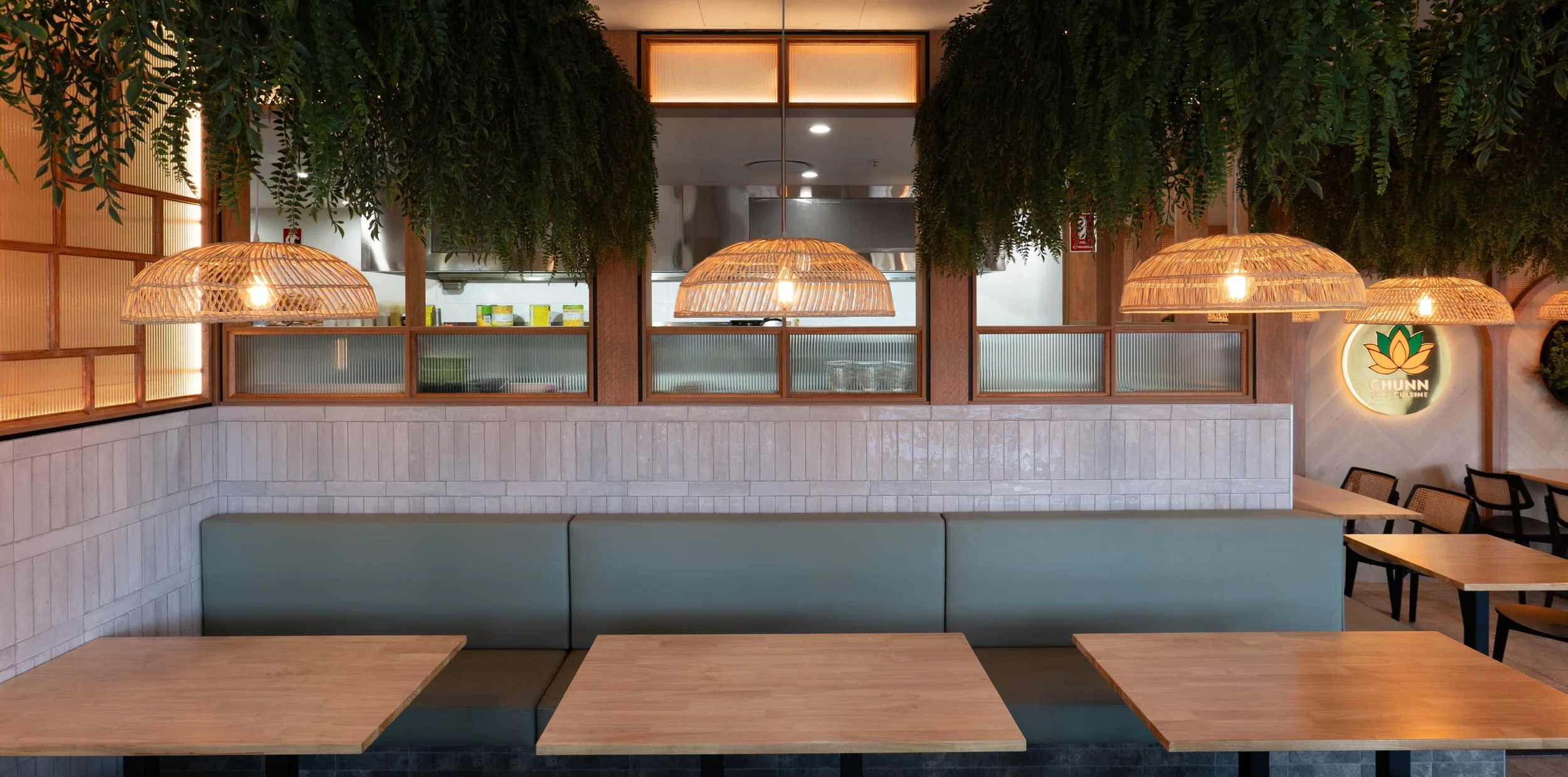 Custom banquette seating with tiled base and comfortable upholstered cushions.