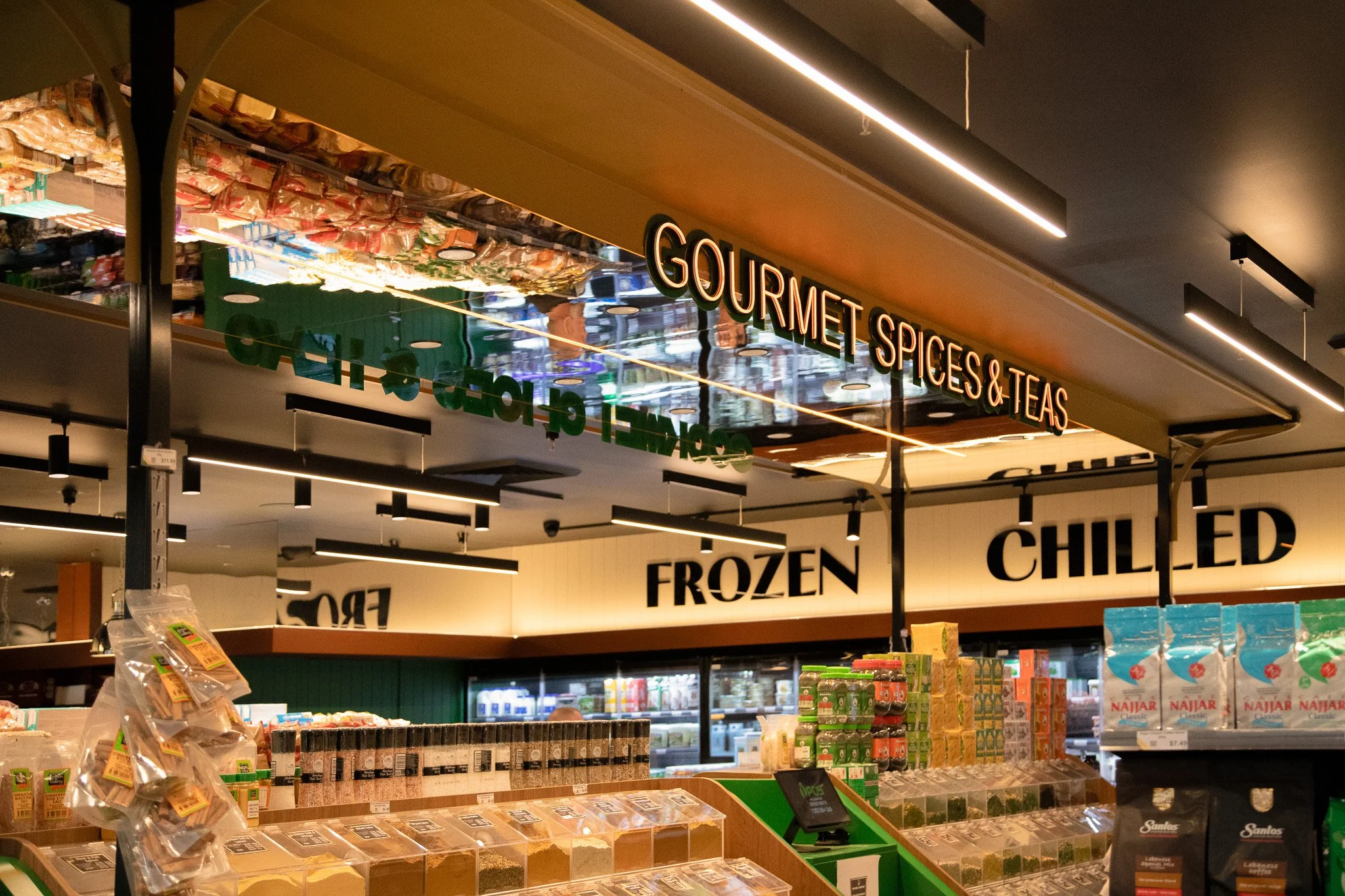 Green Valley Spices branded signage integrated within the completed supermarket interior.