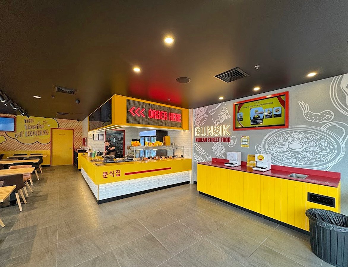 Completed Bunsik Griffith restaurant fit-out featuring a dedicated ordering counter, self-service ramen station and efficient customer service layout.
