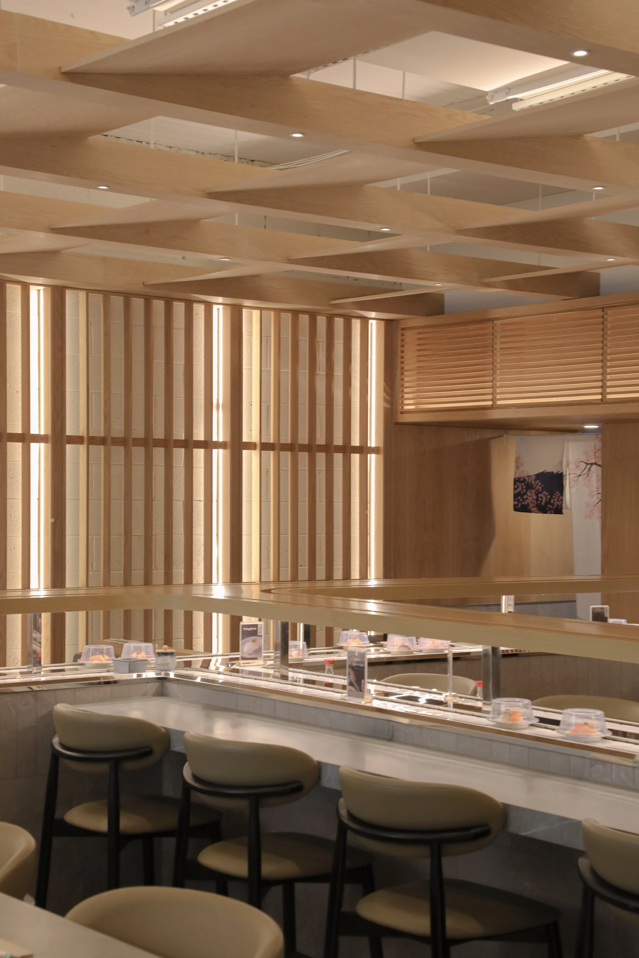 Completed Wonder Sushi Norwest restaurant design featuring layered timber detailing, integrated sushi train and refined material selections.