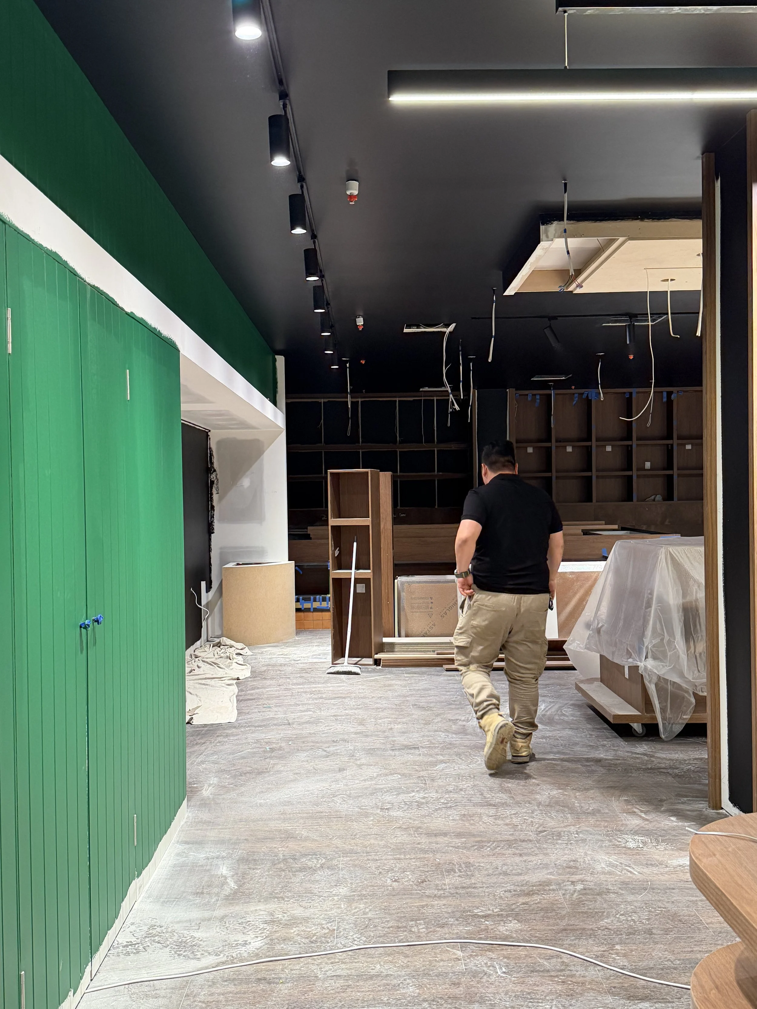 Construction progress of the Green Valley Spice retail fit-out, showcasing the installation of custom joinery, finishes and services.