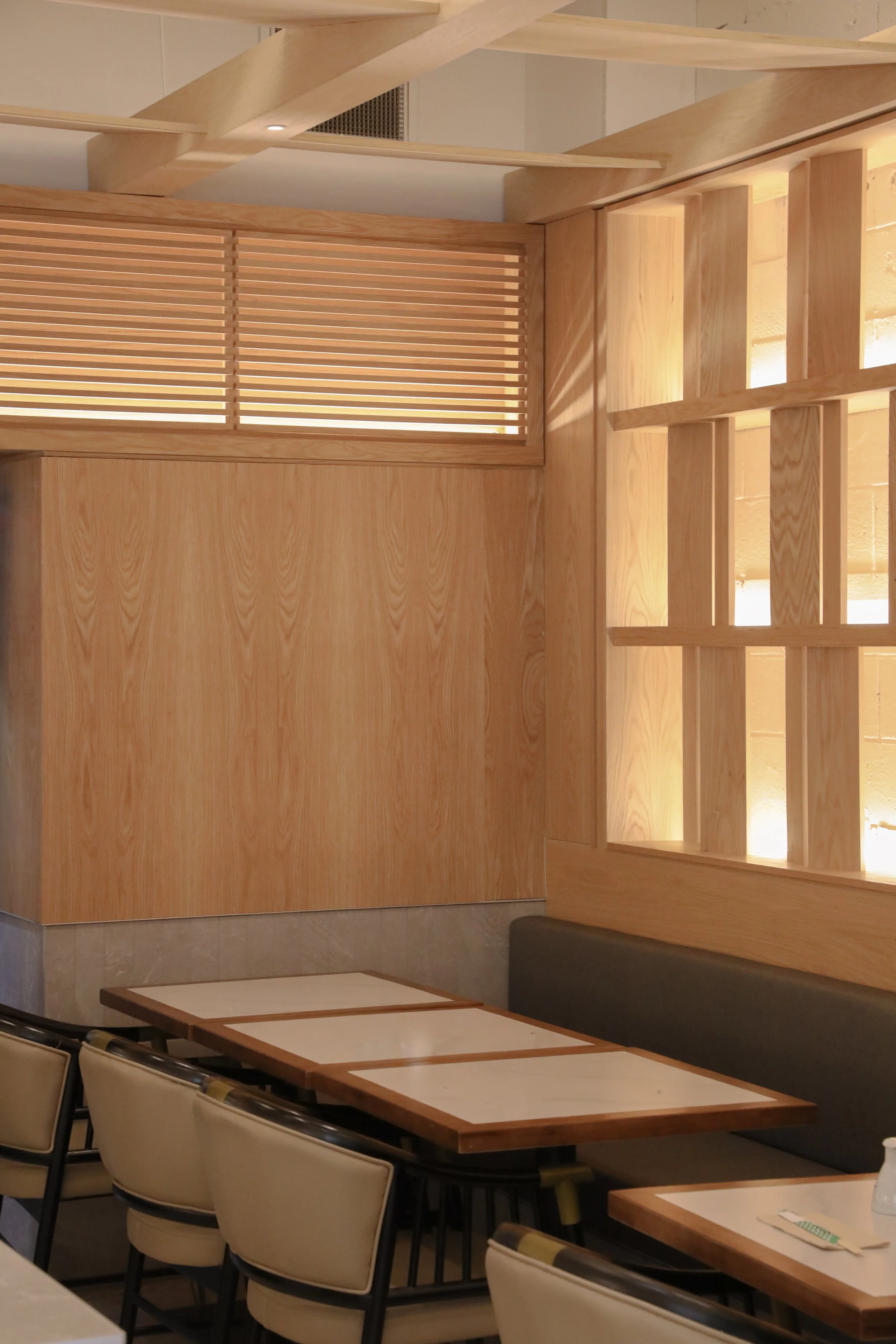 Architectural timber batten detail with integrated LED lighting accentuating the wall and bulkhead junction.