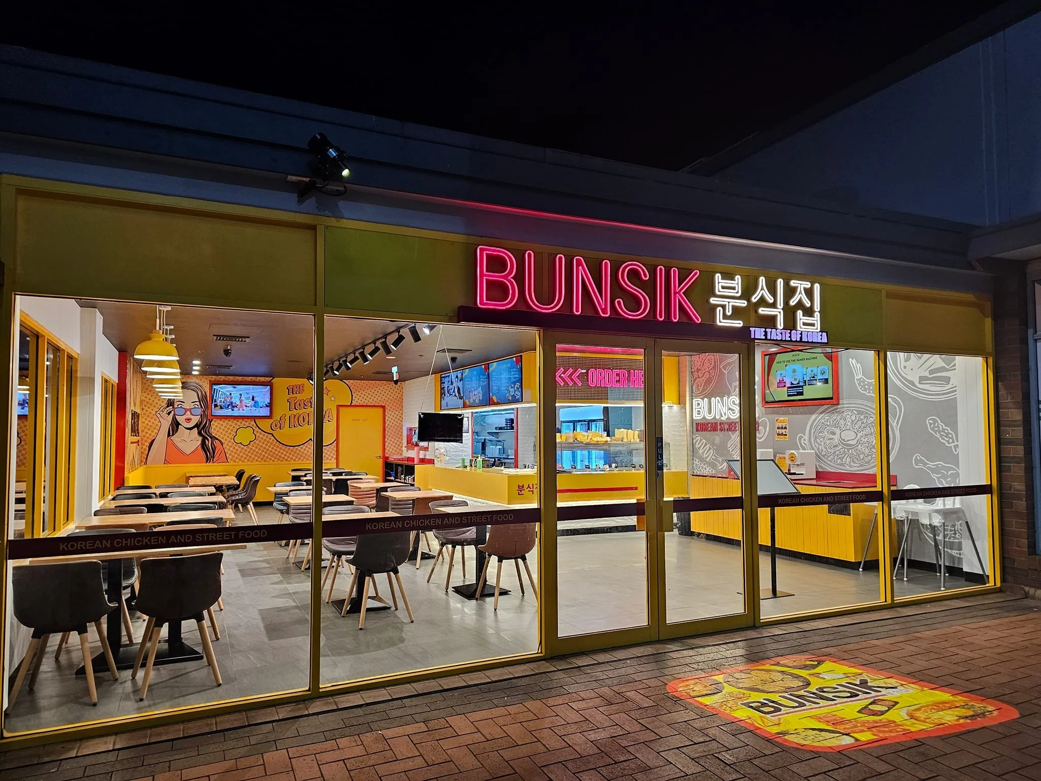 Completed Bunsik Griffith restaurant fit-out showcasing the fully glazed shopfront, branded signage and welcoming customer entry with dedicated ordering and pick-up areas.