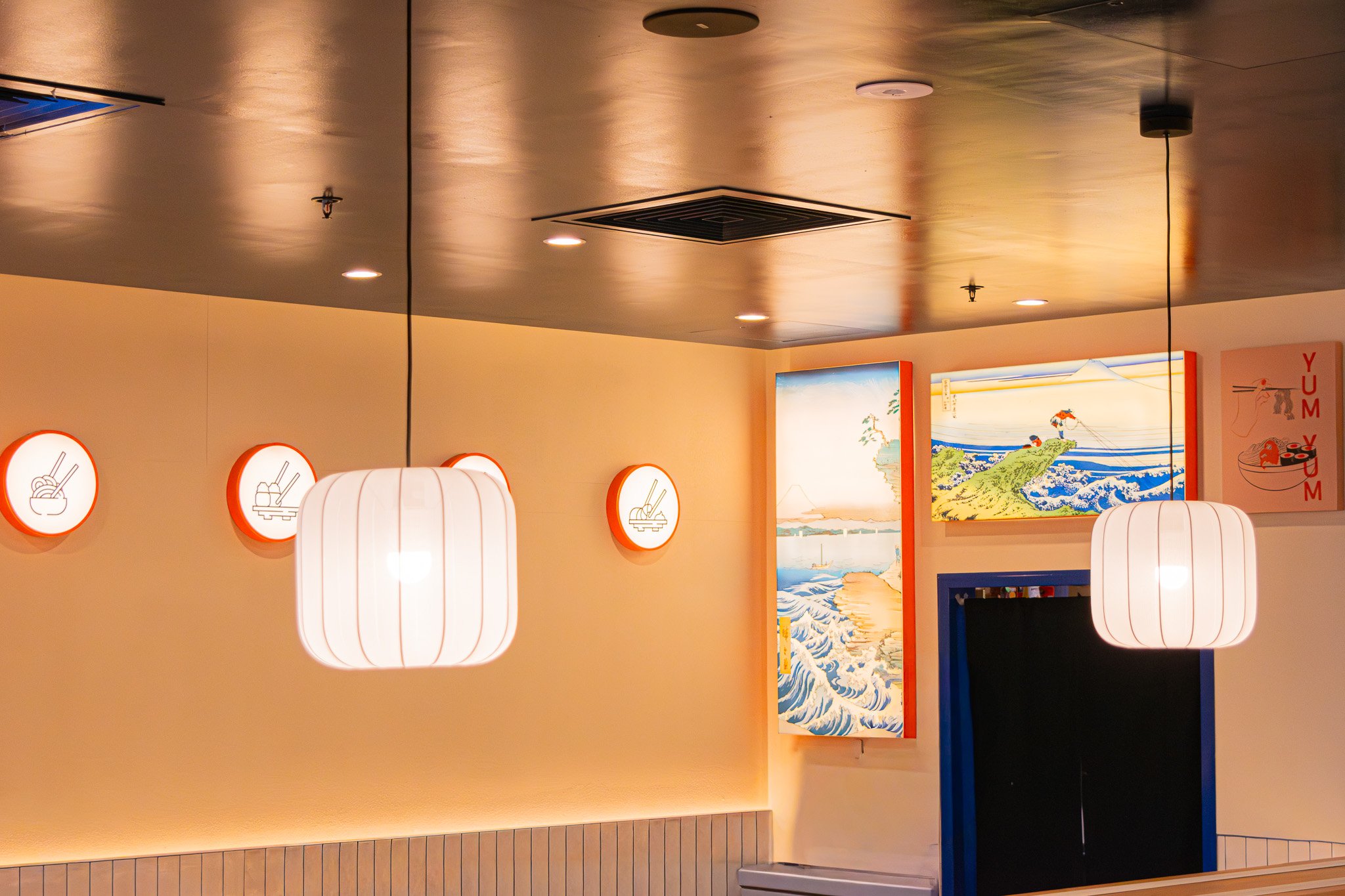 Feature wall with Sushi Culture branding, textured finishes and integrated lighting.