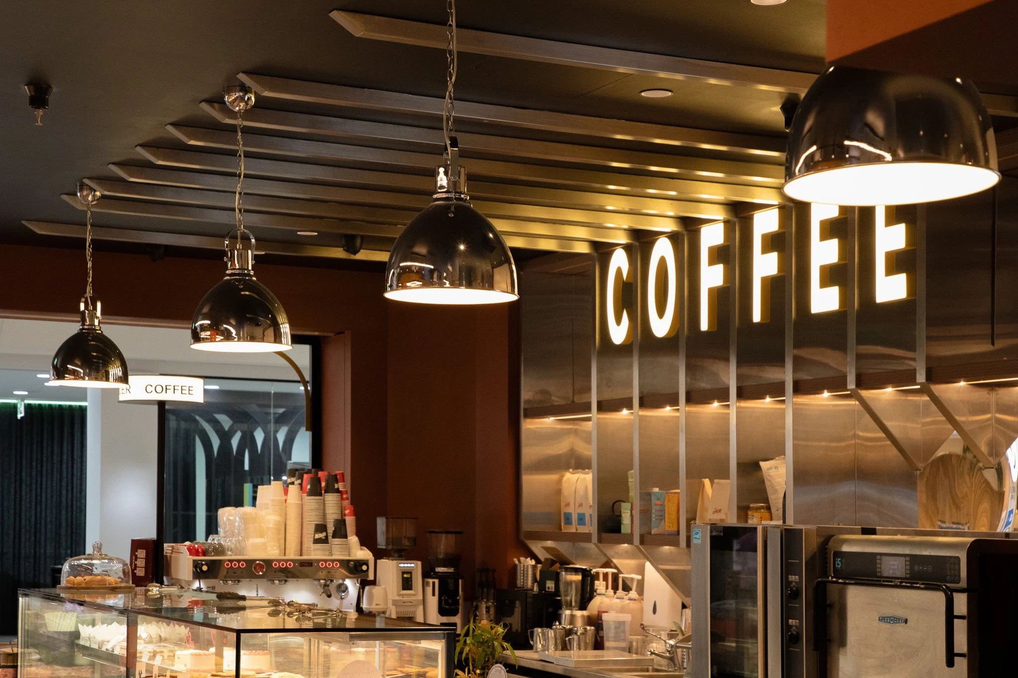 Café section of the finished retail store with custom joinery and signage.