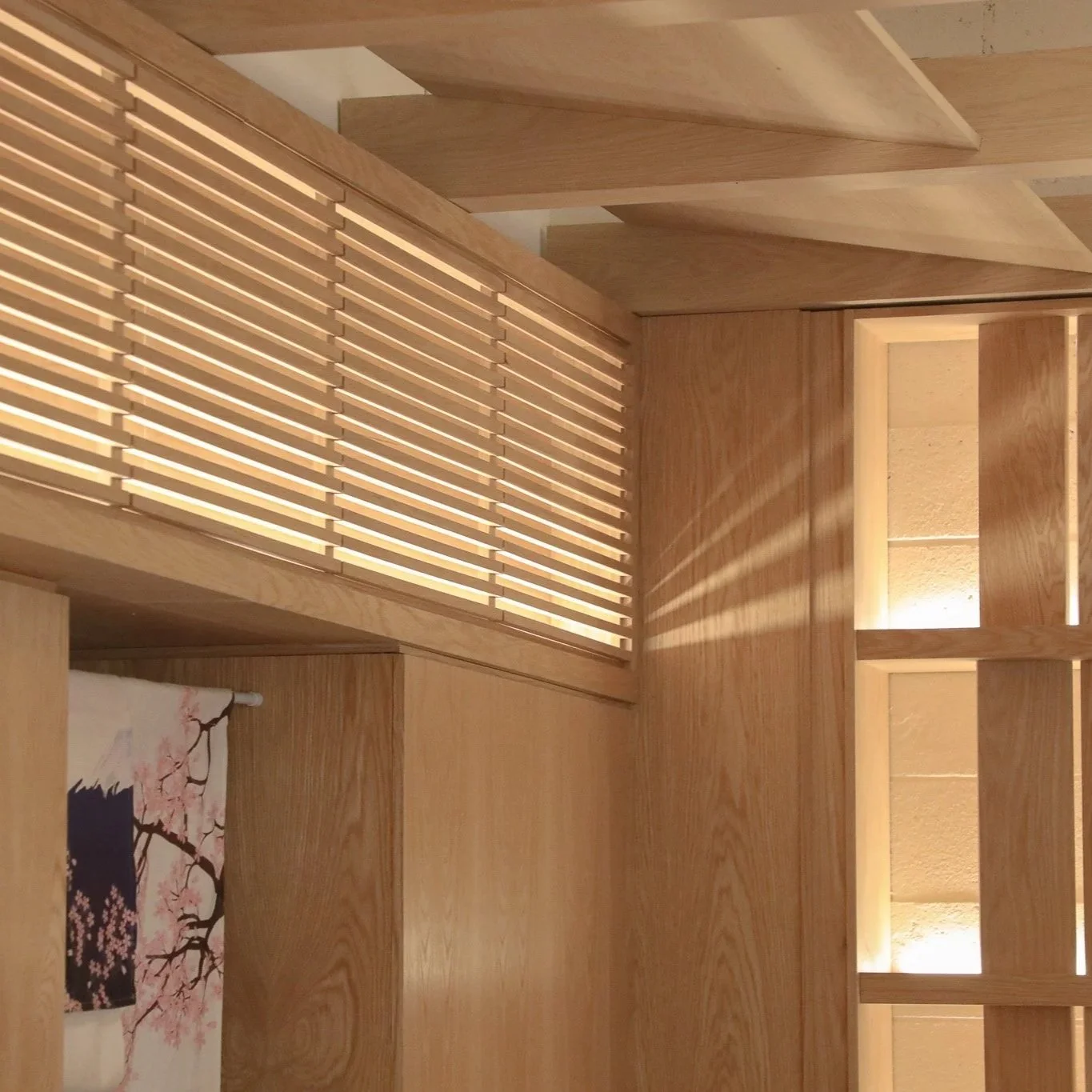 Wonder Sushi Norwest hospitality fit-out featuring a completed timber feature ceiling, bulkhead design and wall battens with detailed craftsmanship and warm material finishes.