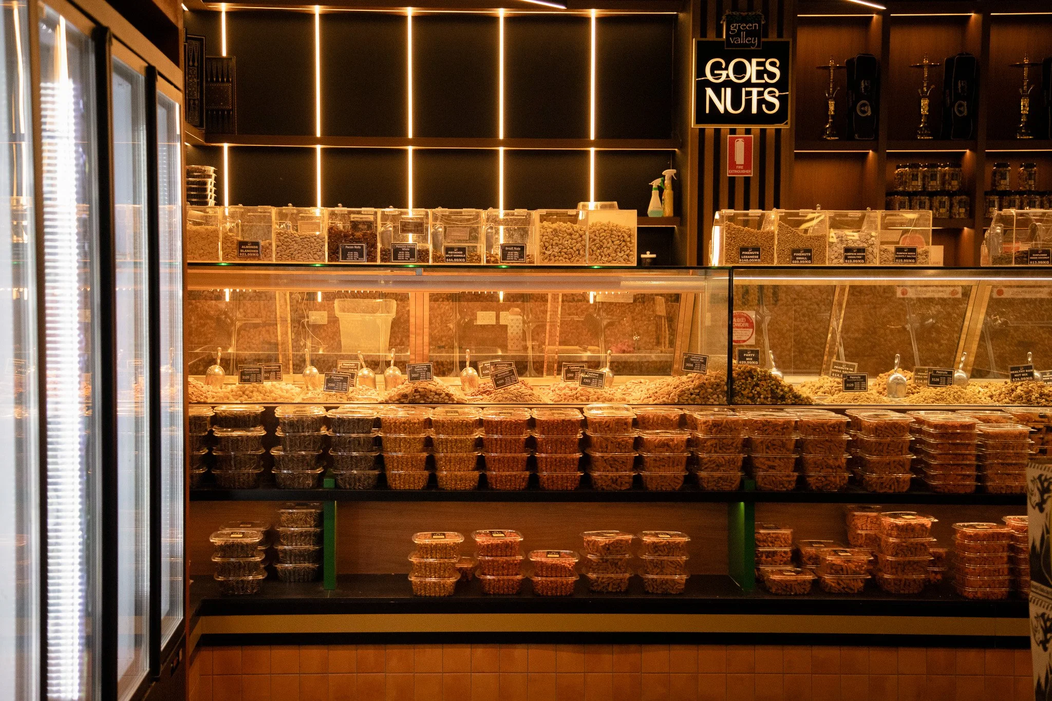 Organised grocery displays within the finished commercial retail space.