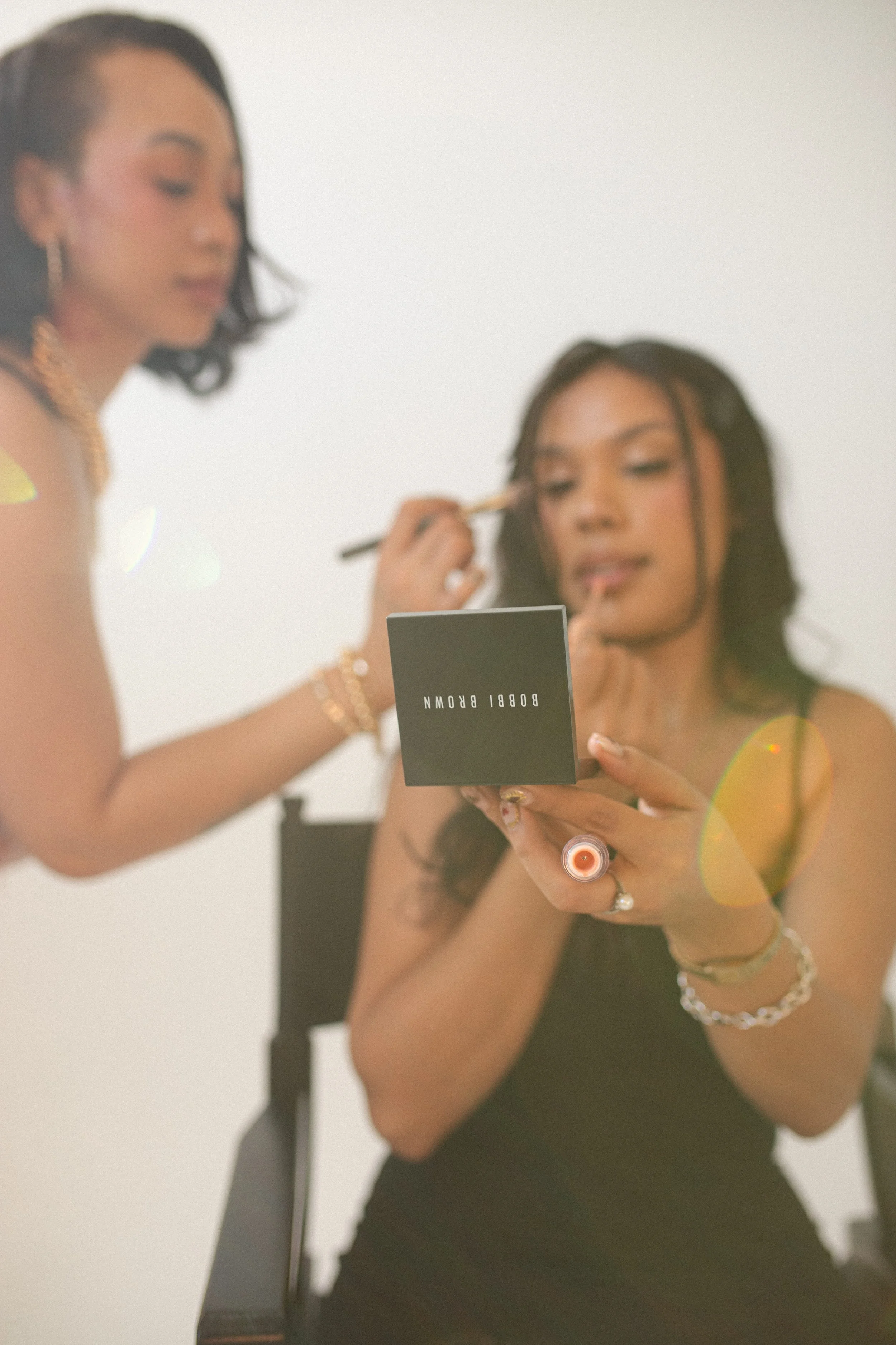 Boise makeup artist glam look with bronzed glowing skin, soft Smokey eyeshadow, bold brows and glossy nude lips.