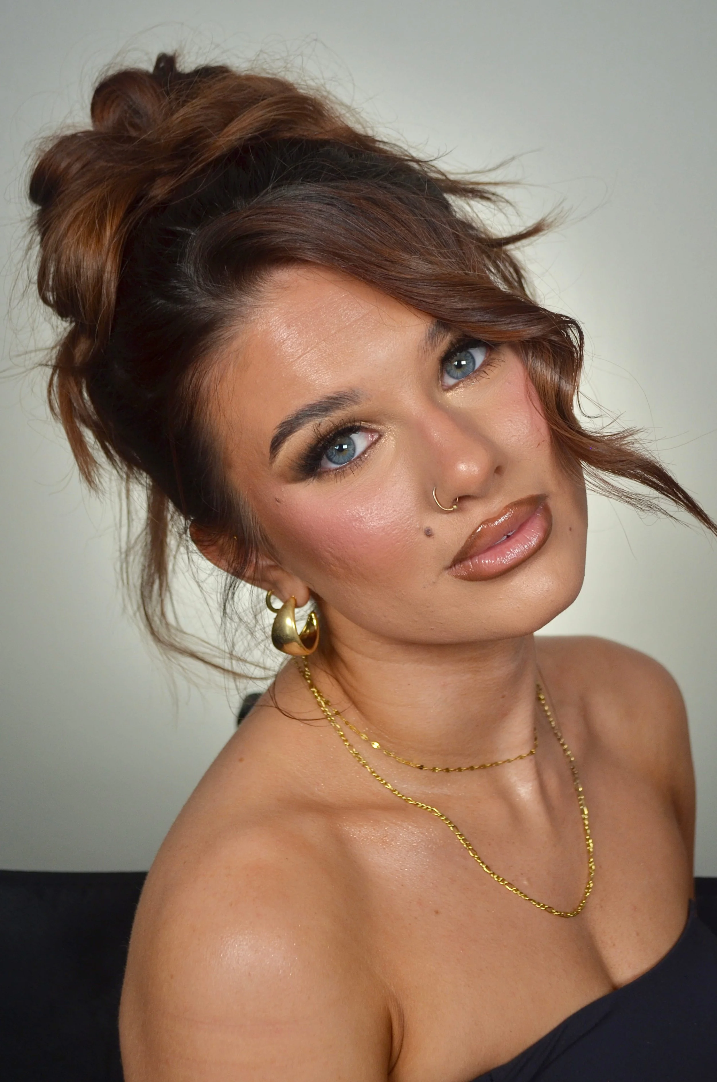 Boise makeup artist soft glam with sharp winged liner, sculpted contour, fluffy lashes, and glossy brown nude lips.