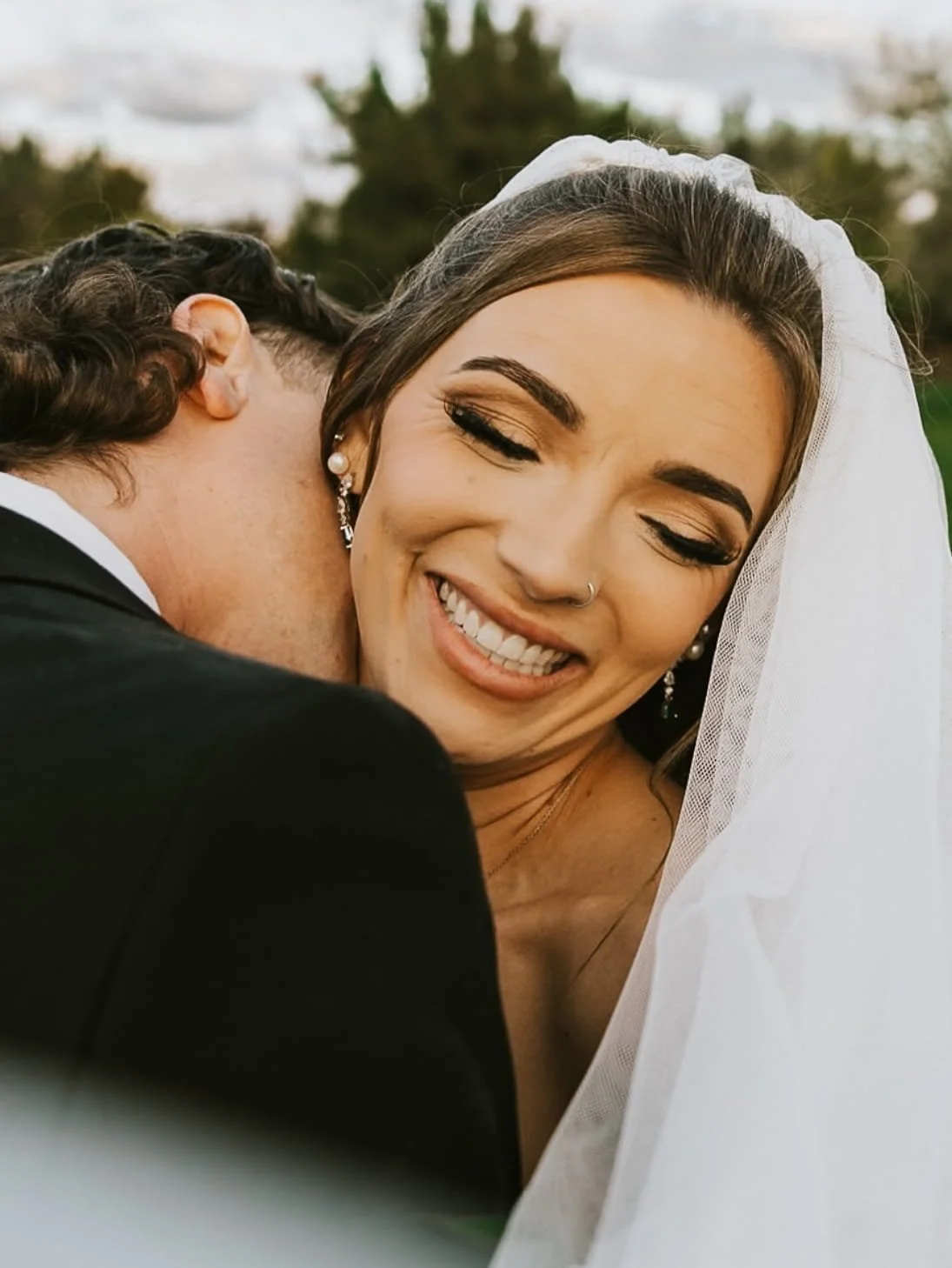 Boise bridal makeup with soft neutral eyeshadow, full lashes, glowing skin and mauve brown lipstick for wedding day look.