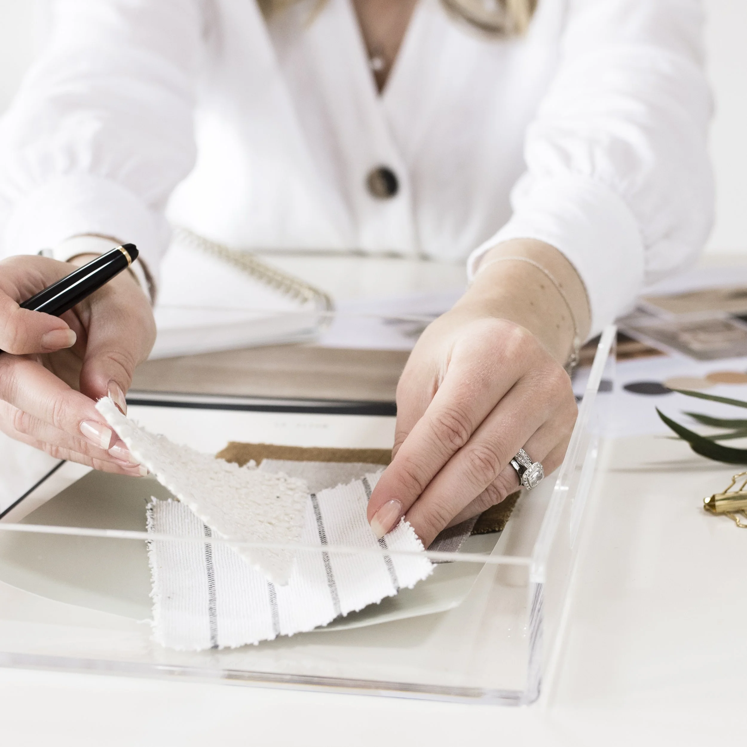 Interior Designing, arranging fabric swatches at a desk with color charts and sample materials.