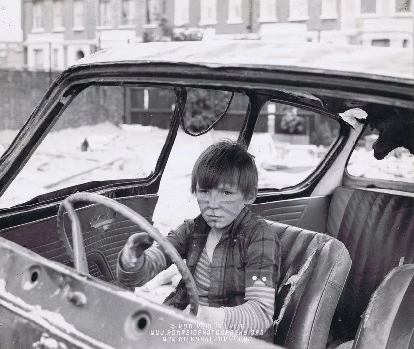 Boy in abandoned car Notting Hill 1970s.jpg